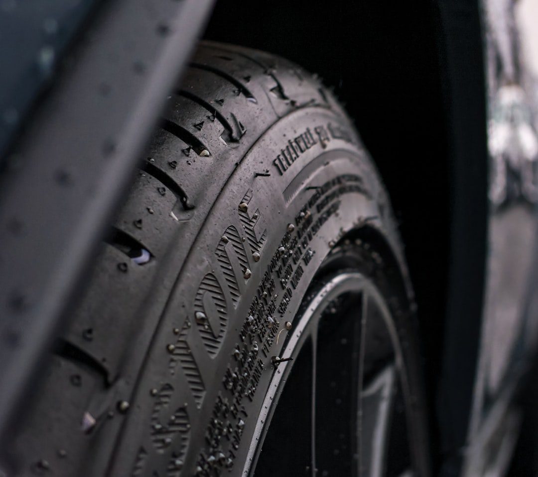 Closeup shot of rubber tire tread sprinkled with water droplets just after the rain.